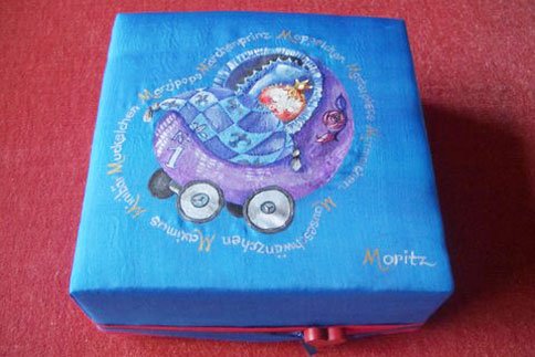 Utensilienkasten,
mit Stoff bezogen und bemalt,
Geschenk anlässlich einer Geburt